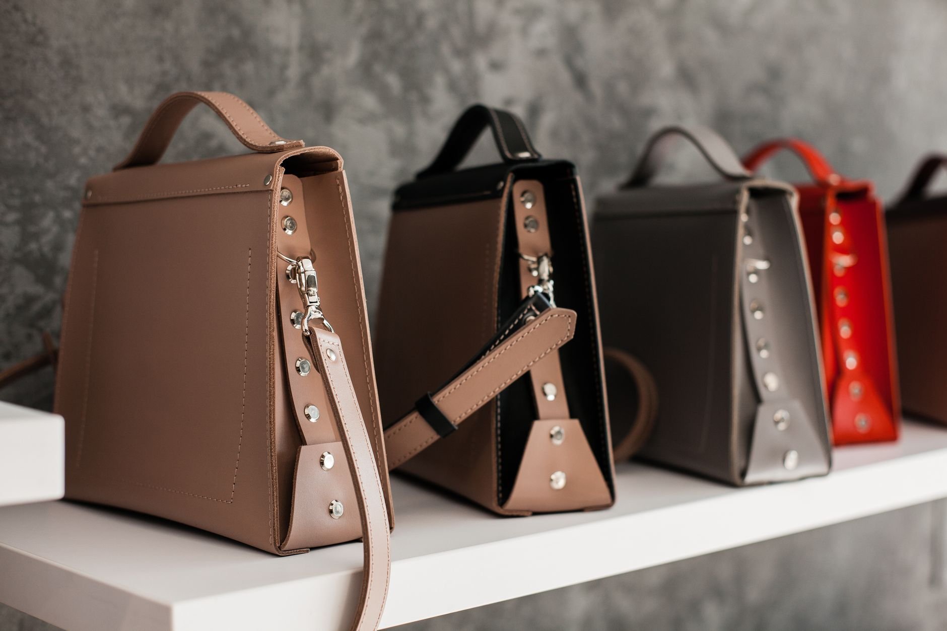 Luxury leather handbags displayed with minimalistic elegance